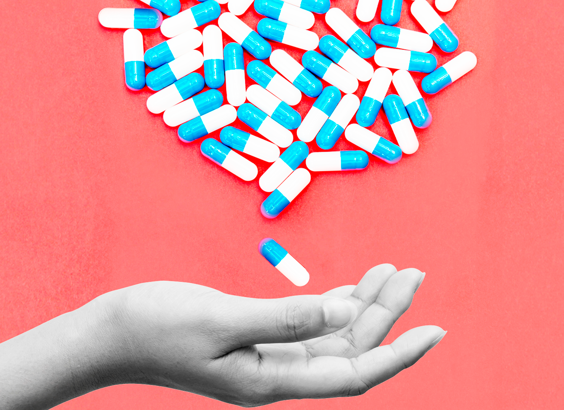 Mano extendida recibiendo pastillas.