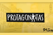 En la pantalla se lee el título del programa "PROTAGONISTAS" en letras blancas y fondo negro. Todo sobre un fondo amarillo