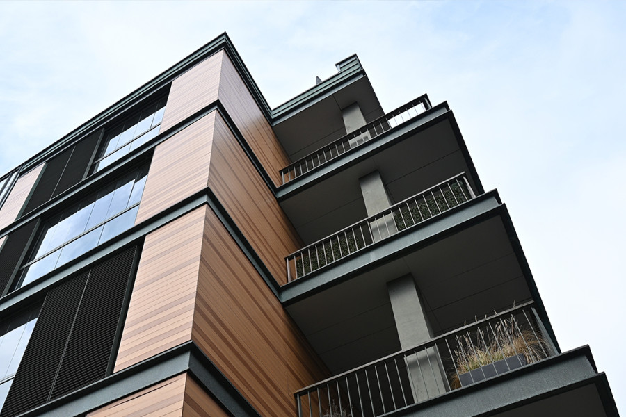 Wooden building viewed from below, you can see the sky.