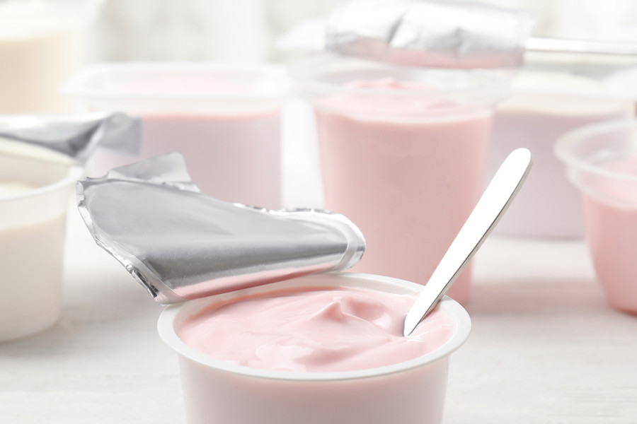 A group of yogurt containers of different flavors.