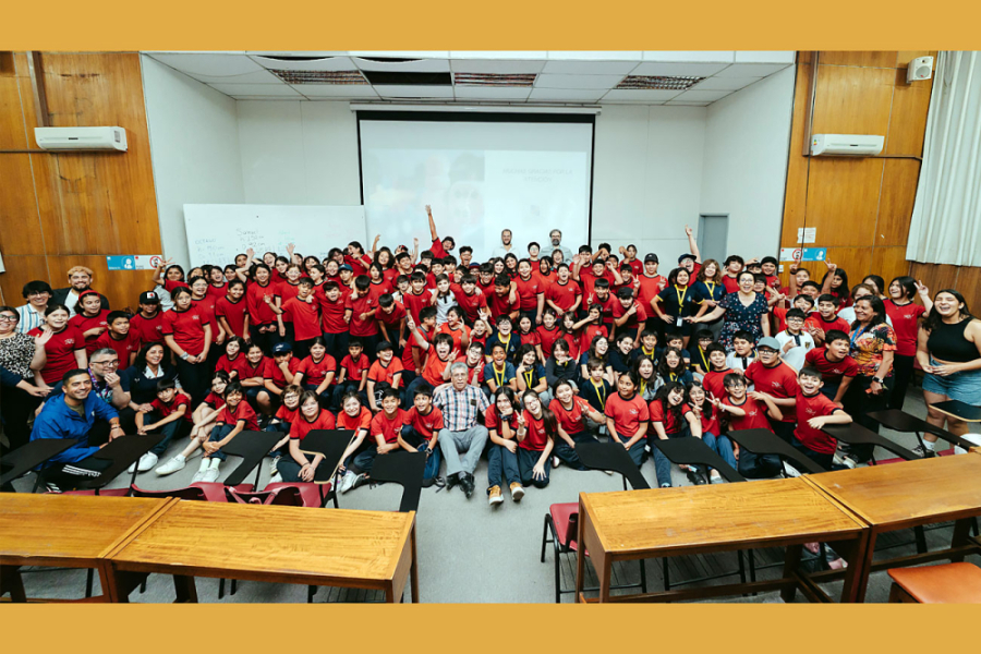 En la imagen aparecen cientos de niños de los colegios participantes del evento en el escenario central del Auditorio Enrique Froemel
