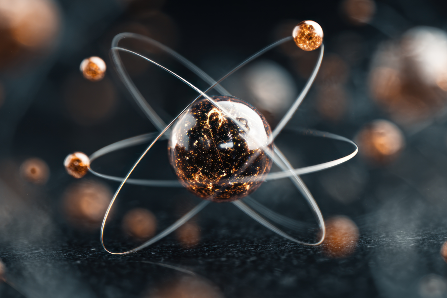 Modelo atómico en 3D que muestra electrones brillantes orbitando alrededor de un núcleo central.
